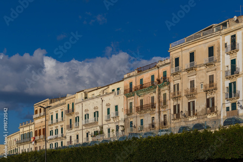 Row of buildings at the tree-lined seafront promenage on the Isle of Ortygia © srekap