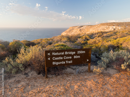 Sign for Natural Bridge and coastal cliffs in Kalbarri National Park, Western Australia photo