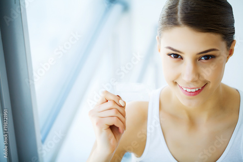 Teeth Whitening. Beautiful Smiling Woman Holding Whitening Strip. High Resolution Image © Maksymiv Iurii