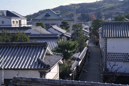 View of the historical Kurashiki city with Japanese traditional painted houses and a rickshaw man. Taken in Okayama, Japan.