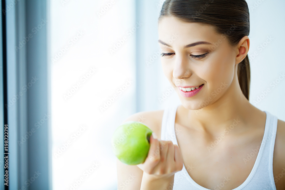 Smiling Woman With Beautiful Smile, White Teeth Holding Apple. High Resolution Image Smiling Woman With Beautiful Smile, White Teeth Holding Apple. High Resolution Image