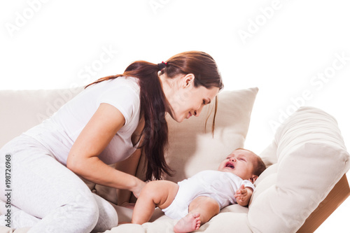 Young mother soothes baby