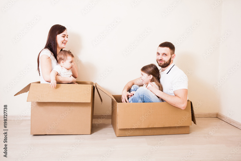 Family unpacking cardboard boxes