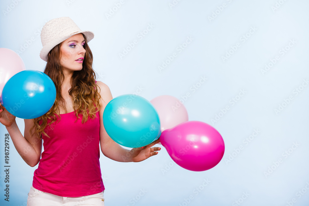 Woman playing with many colorful balloons Woman playing with many colorful balloons