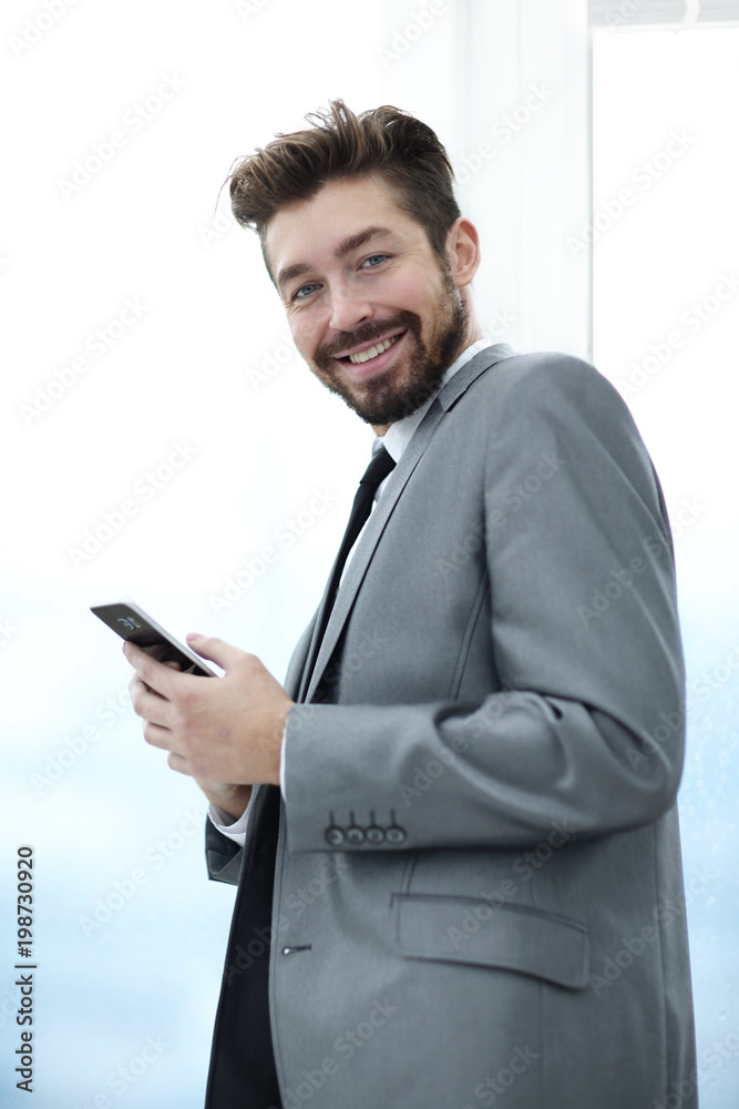 Stylish man in suit is reading information on phone Stylish man in suit is reading information on phone