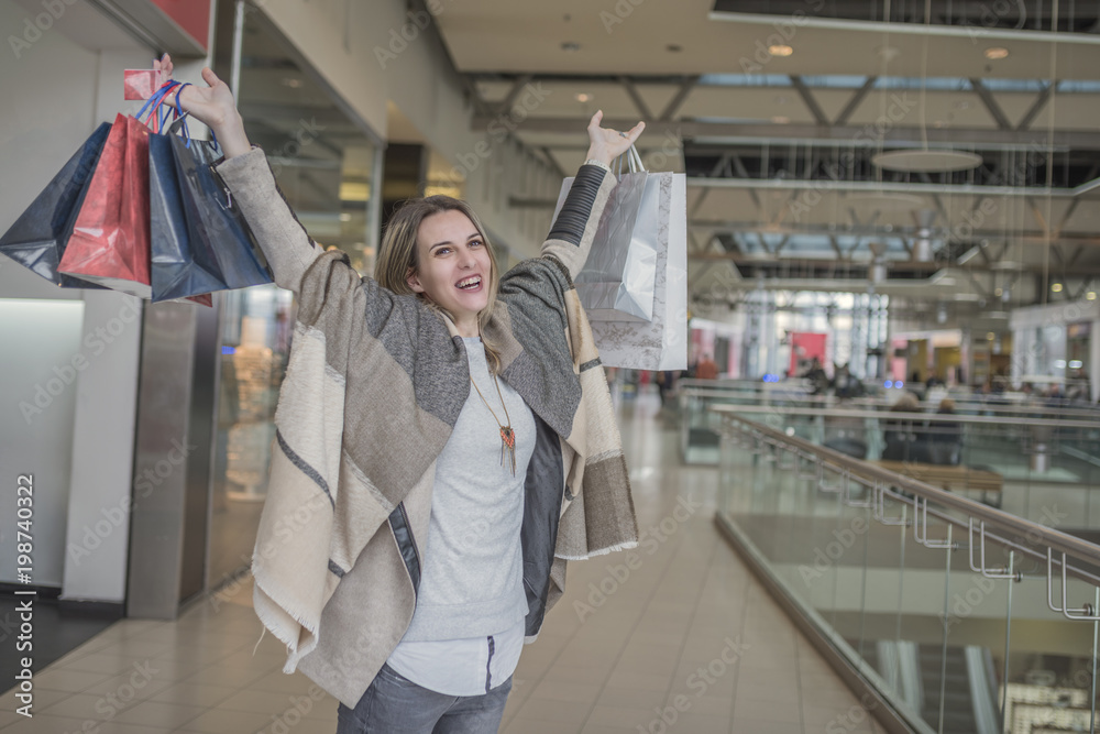 Smiling girl with Shopping Bags in Shopping Mall Smiling girl with Shopping Bags in Shopping Mall
