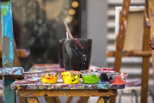Canvas Print paint and brushes on a clorful table