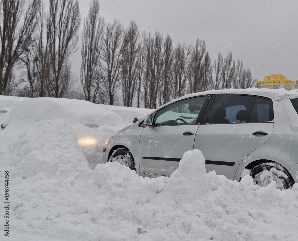 Car get stuck in snow at open parking lot after heavy snowstorm