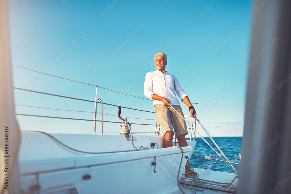 Naklejka premium Mature man out for a sail on his boat