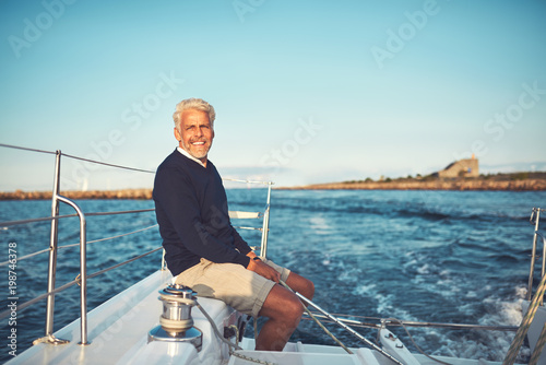 Mature man enjoying a day sailing on the ocean