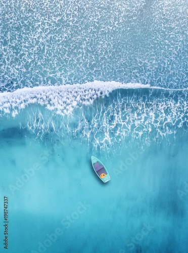 Wave and boat on the beach as a background. Beautiful natural background at the summer time from air