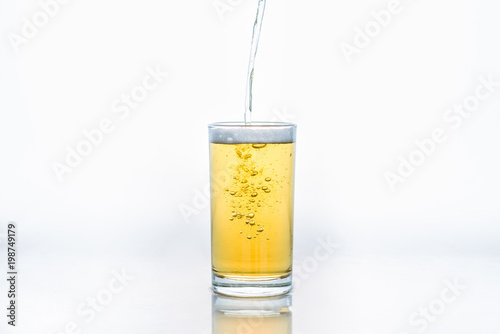 Pour glass of beer on white background