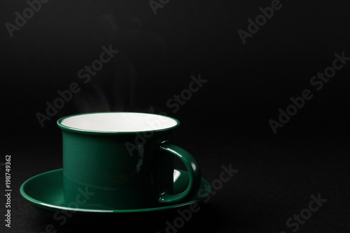 Fototapeta Naklejka Na Ścianę i Meble -  strong black coffee in a mug of emerald color on a black matte background