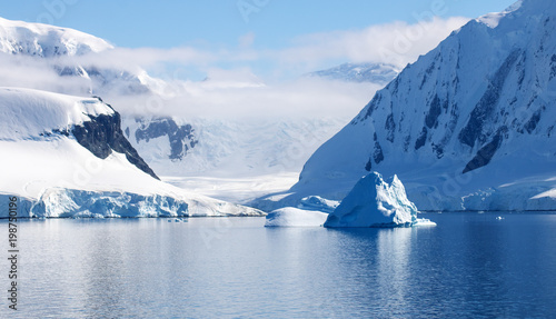 Beautiful Neumayer Channel, Antarctica. Snowcapped mountains, icebergs, calm waters and blue skies