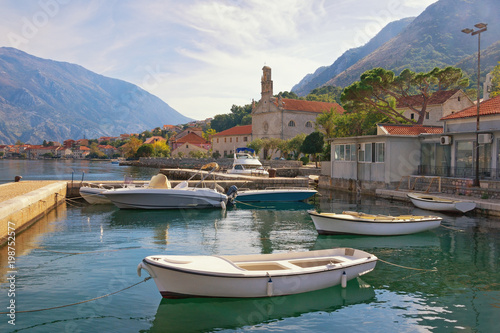 Sunny autumn day. Montenegro, Bay of Kotor. View of seaside Prcanj town and St. Nicholas Church