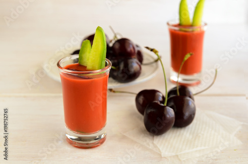 Cherry gazpacho served in glass shot, this Spanish raw soup is very refreshing and perfect for hot summer. Healthy food and raw food ideas.