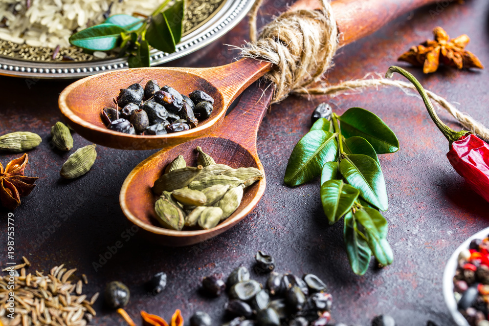 Spices for cooking with kitchen accessories on an old background Spices for cooking with kitchen accessories on an old background