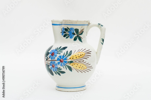 Old jug with painted flowers