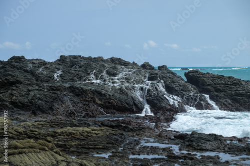 rocks at the Siung beach with draining water - tears of the ocean photo