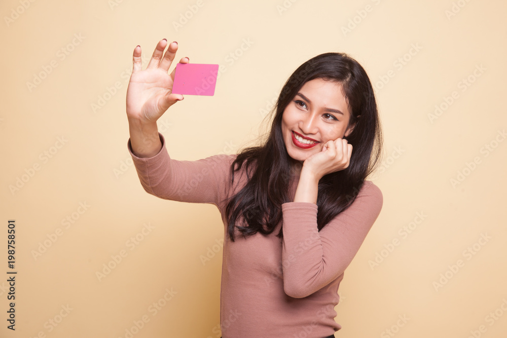 Happy young Asian woman with a blank card. Happy young Asian woman with a blank card.
