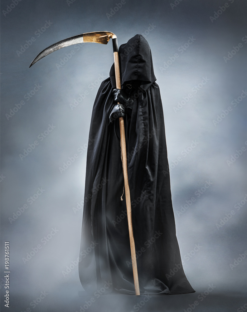 Fototapeta premium Grim Reaper standing in the fog at night. Photo of personification of death wielding a large scythe in silhouette.