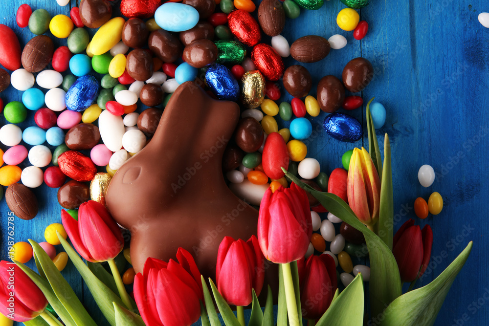 Chocolate Easter eggs and bunny with fresh easter flower