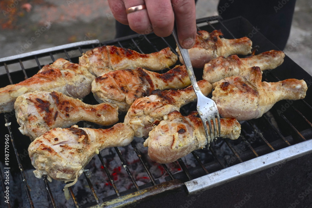 Grilled chicken thigh on the flaming grill