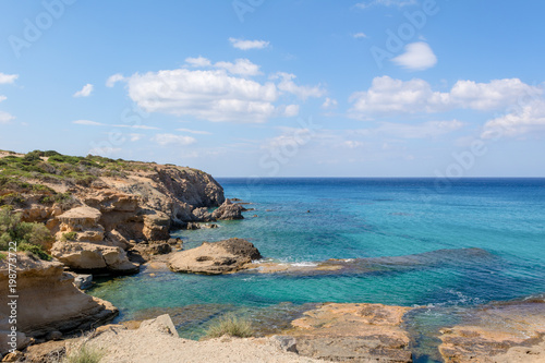 Rocky coast and blue sea water/ Milos island, Greece