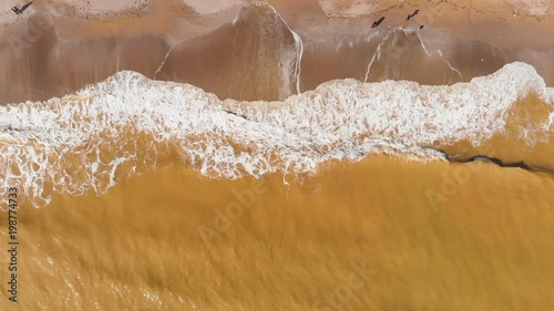 Aerial view of clay-polluted sea coast. Muddy sea water. Environmental contamination. Chemical accident. Video shot with a drone.