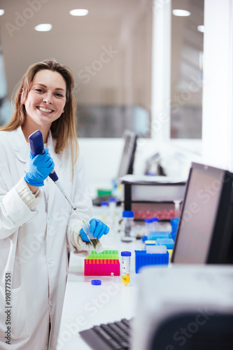young woman scientist working with a pipette in a laboratory