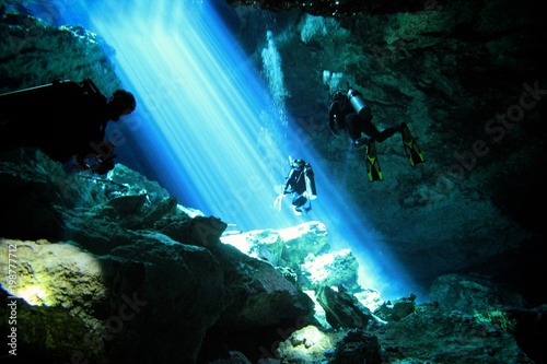 Beautiful beams of light in a Cave and Cavern during a Scuba Diving exploration of a sinkhole or Cenote in the riviera Maya, Mexico