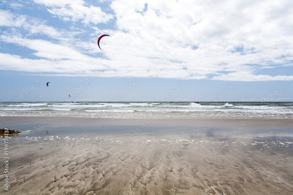View of kite surfers from a beach, in Estero Bluffs State Park, California