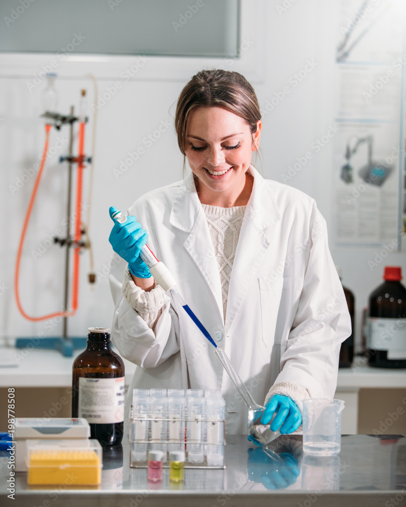 young woman scientist working with a pipette in a laboratory young woman scientist working with a pipette in a laboratory