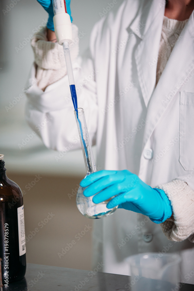 young woman scientist working with a pipette in a laboratory young woman scientist working with a pipette in a laboratory