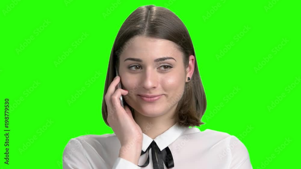 Portrait of sexy girl talking on phone flirting with someone. Cute young brunette woman. Green screen hromakey background for keying. Portrait of sexy girl talking on phone flirting with someone. Cute young brunette woman. Green screen hromakey background for keying.