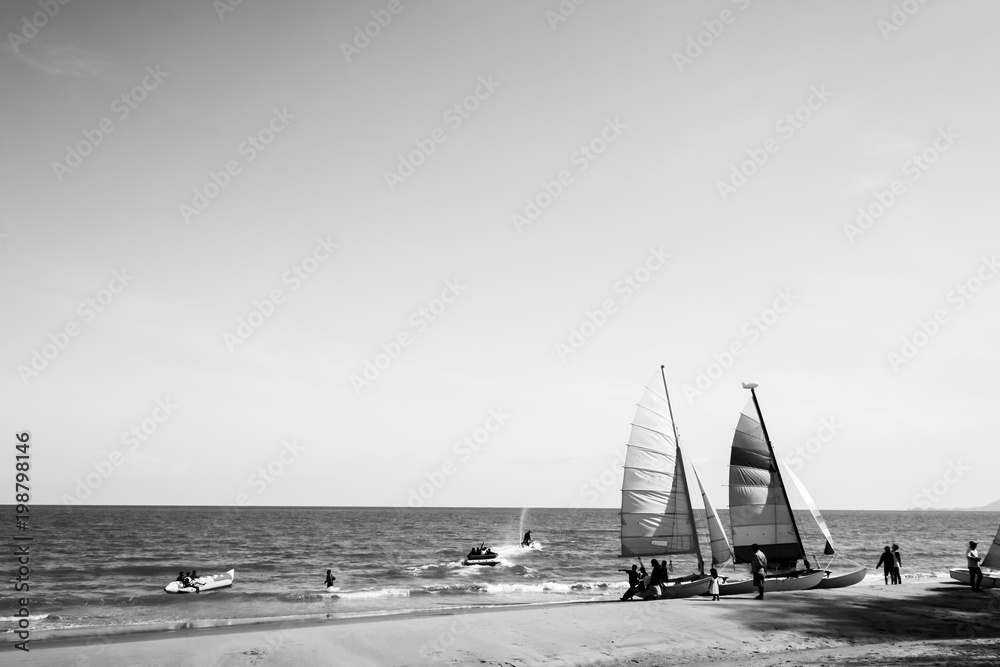 Colorful sailboat on tropical beach in summer. Black and White color