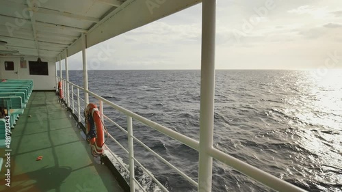 A view of the sea of the Palawan Islands in the rays of the sunset. Fascinating beauty. Sea immensity. Shooting in motion on a moving ferry. The city of Coron. Philippines. photo