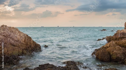 Time lapse of sea have stone on sunset photo