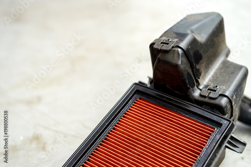 closeup old air filter for car in the garage with soft-focus and over light in the background