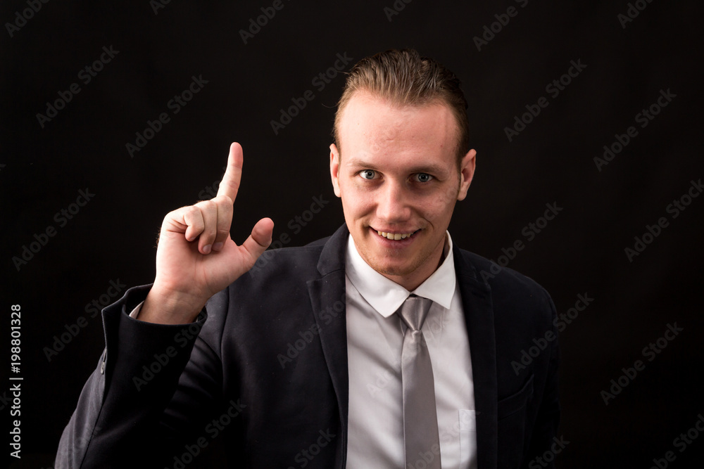 Businessman pointing copy space isolated on black background Businessman pointing copy space isolated on black background