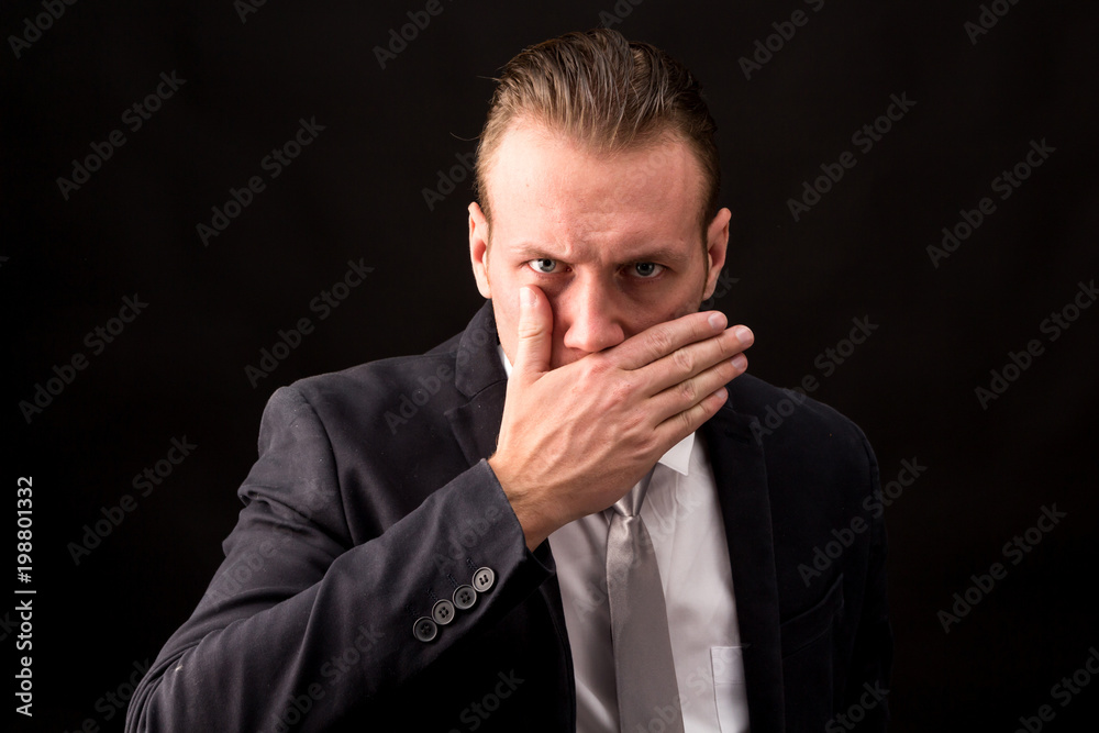Businessman with black suit isolated on black background