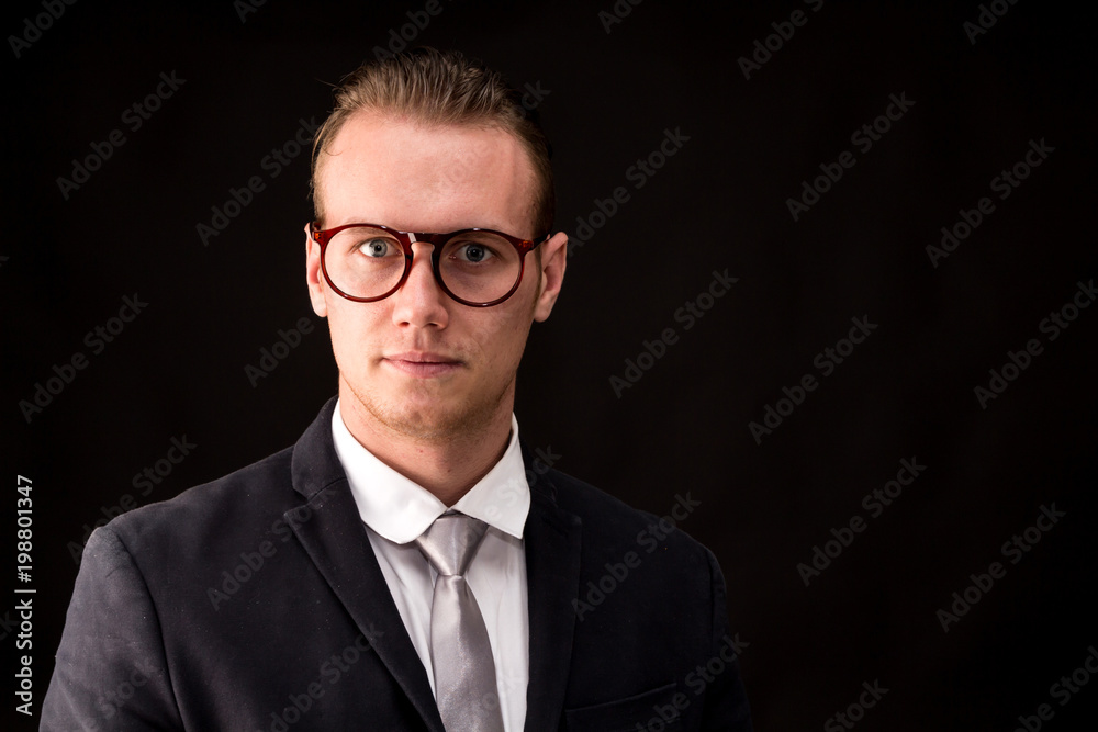 Businessman with black suit isolated on black background Businessman with black suit isolated on black background