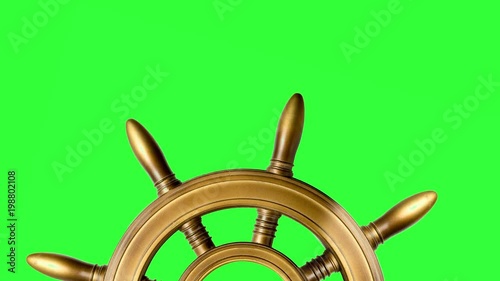 half of old ship vintage, wooden steering wheel isolated on chroma key background turning at the bottom of the screen with copy space at the top. 