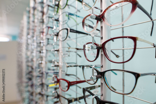 stand with eyeglasses in the store.
the choice of spectacles for the correction of vision.
choice of sunglasses