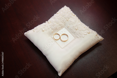 Engagement gold rings on the pillow