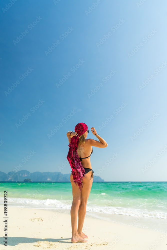 Woman with pink sarong on the tropical beach Woman with pink sarong on the tropical beach