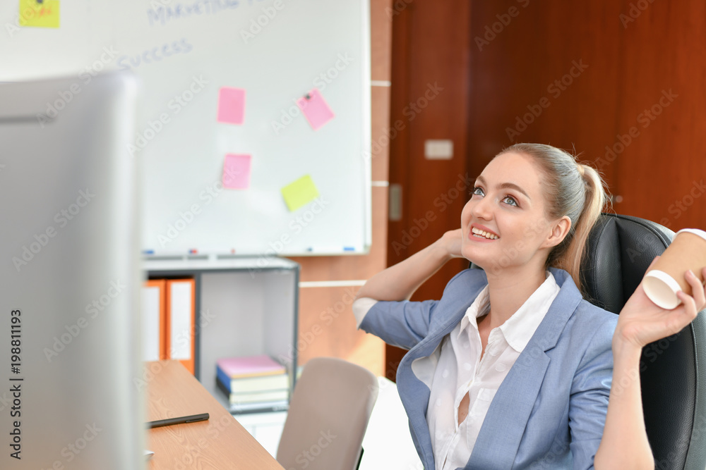 Business Concepts. Beautiful businesswoman is working in office. Beautiful young businesswoman is working on a computer. Beautiful young businesswoman is working happily.