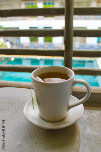 Cup of tea on the background of the swimming pool