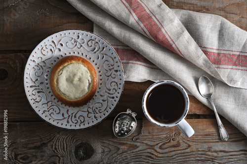cheesecake, tea in a mug on wooden rustic background