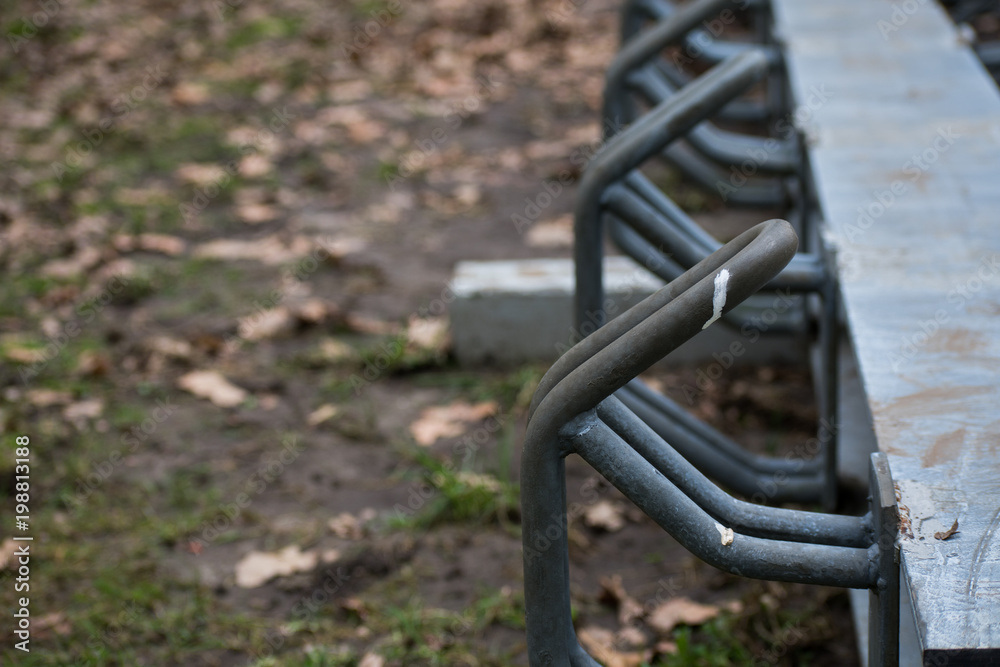 Grey Metal Steel Empty Bike Rack Or Bicycle Stand In Forest Grass Nature Grey Metal Steel Empty Bike Rack Or Bicycle Stand In Forest Grass Nature